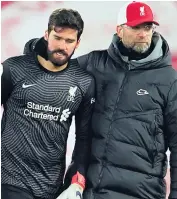  ??  ?? Jurgen Klopp consoles Alisson Becker