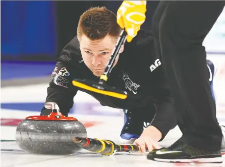  ??  ?? Skip Mike Mcewen delivers a rock during the wild card game against Glenn Howard’s rink at the Brier in Kingston, Ont. on Friday.
Mcewen’s rink won 5-4 and will compete as Team Wild Card when regular Brier play begins Saturday. SEAN KILPATRICK/THE CANADIAN PRESS