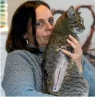  ??  ?? Poura the cat, pictured with owner Bettina Fratucelli, was shot in September, on the same street as Smudge. SCOTT HAMMOND/STUFF
