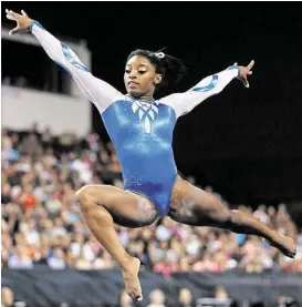  ?? Andrew A. Nells / Associated Press ?? Simone Biles shows off her form in the floor exercise Saturday during the Secret U.S. Classic in Hoffman Estates, Ill.