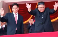  ??  ?? Kim (right) and Li wave while attending a military parade marking the 70th anniversar­y of North Korea’s foundation in Pyongyang, North Korea. — Reuters photo