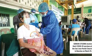  ??  ?? SENIOR CITIZENS receive their COVID-19 vaccines at the San Jose Parish Church in Navotas on March 31.