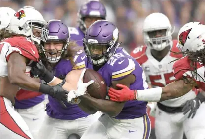  ?? GETTY IMAGES ?? Vikings running back Latavius Murray breaks a tackle on his way to a 21-yard TD run in the first quarter against the Cardinals.