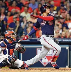  ?? ELSA / GETTY IMAGES ?? Nationals left-fielder Juan Soto hits a tying solo home run off Astros ace Gerrit Cole during the fourth inning of Game 1 of the World Series on Tuesday. Soto later added a two-run double in the 5-4 win.