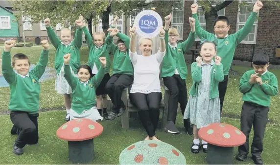  ??  ?? West Rainton Primary School deputy head Susan Firth and pupils celebrate the school’s second successive Inclusion Quality Mark Award.