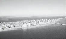  ?? CHRISTOPHE VISEUX/THE NEW YORK TIMES ?? A tank farm for crude oil and refined products in Ras Tanura, Saudi Arabia. Saudi Aramco said it has been evaluating a number of acquisitio­n opportunit­ies, both locally and globally as part of the company’s strategy to rebalance its portfolio