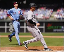  ?? MATT SLOCUM — THE ASSOCIATED PRESS ?? The Marlins’ Nick Fortes, right, scores on a wild pitch by Kyle Gibson of the Phillies during the sixth inning of Thursday’s game in Philadelph­ia.