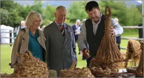  ?? Photo Valerie O’Sullivan ?? The royal couple are given a demonstrat­ion of Straw making by Pat Broderick at Muckross Traditiona­l Farms during their visitin June.