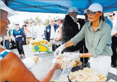  ??  ?? Jonathan Ernst Reuters First lady Melania Trump and President Donald Trump hand out sandwiches, joined by Vice President Mike Pence, to Hurricane Irma victims Thursday during their tour of storm recovery efforts in Naples, Fla.