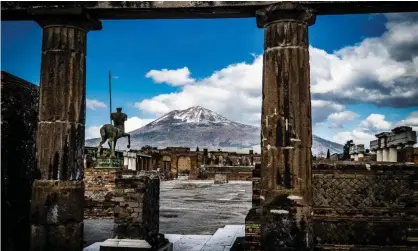  ?? Photograph: Cesare Abbate/ EPA ?? The peak of Mount Vesuvius is seen from the streets of the archaeolog­ical site in Pompeii, Italy, in February.