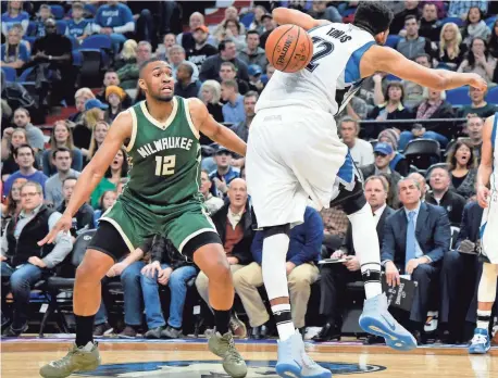  ?? ASSOCIATED PRESS ?? Milwaukee Bucks forward Jabari Parker watches as Minnesota Timberwolv­es center Karl-Anthony Towns loses control of the ball Friday night.