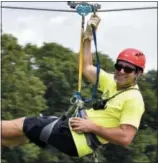  ?? SHANNON SEPER — ECO ADVENTURE ZIPLINES VIA AP ?? Mike Seper hangs on a zipline at Eco Adventure Ziplines in New Florence, Mo. “While I considered deleting Facebook, I understand the importance and reach Facebook has to keep an open channel of communicat­ion with our customers,” says Seper, owner of...