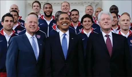  ?? SUSAN WALSH — THE ASSOCIATED PRESS FILE ?? President Barack Obama, flanked by Vice President Joe Biden, left, and former President Bill Clinton, right, pose for a photo with the U.S. World Cup soccer team under the North Portico of the White House in Washington, May 27, 2010.