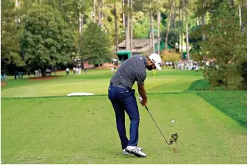  ?? AP Photo/David J. Phillip, Files ?? ■ Dustin Johnson tees off on the sixth hole Nov. 15, 2020, during the final round of the Masters golf tournament in Augusta, Ga. Johnson’s birdie on this hole was pivotal in winning the Masters last year.