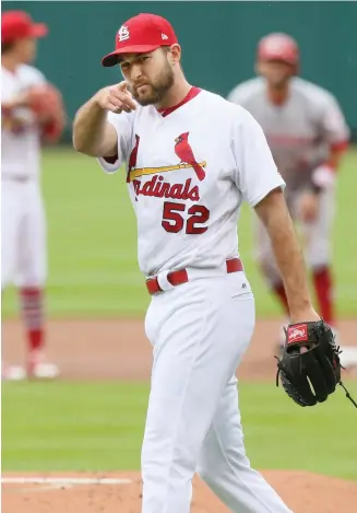  ?? (Photo by Chris Lee, St. Louis Post-Dispatch, AP) ?? St. Louis Cardinals starting pitcher Michael Wacha acknowledg­es catcher Yadier Molina after Molina threw out Cincinnati Reds’ Jose Peraza trying to steal second in the first inning of Monday’s game.