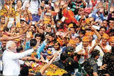  ?? SANJAY KANOJIA/AFP ?? Indian Prime Minister Narendra Modi gestures during a roadshow in support of state assembly election party candidates in Varanasi on Saturday.