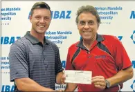 ?? Picture: MELISSA AWU ?? GOOD DAY’S WORK: Madibaz deputy director Petrus Boukes, right, hands over R23 000 to Mike Usendorff for the Els For Autism Charitable Foundation. The funds were generated through Usendorff’s golf marathon at Humewood last year, with R23 000 also being...