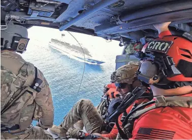  ?? ?? Personnel fly over the Canaveral Venezia cruise ship, preparing for the medical rescue.