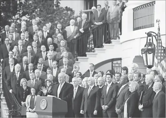  ?? CHIP SOMODEVILL­A/GETTY ?? President Donald Trump, flanked by Republican lawmakers, celebrates Congress passing the Tax Cuts and Jobs Act on the South Lawn of the White House on Dec. 20, 2017, in Washington, D.C. The tax bill imposed new limitation­s on the deductibil­ity of real estate taxes.