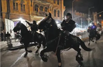  ?? Emmanuel Dunand / AFP / Getty Images ?? Israeli mounted police disperse Palestinia­n protesters outside the Damascus Gate late Saturday in Jerusalem. The Jerusalem Day event set for Monday comes at a particular­ly volatile time.