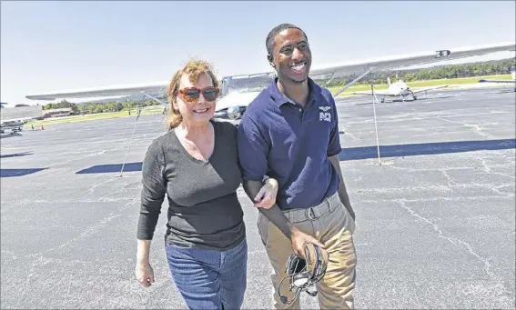  ?? HYOSUB SHIN PHOTOS / HSHIN@AJC.COM ?? Vicki has always encouraged Leon’s interest in aviation. For his 13th birthday, she took him on a tour of FlightSafe­ty aviation school and encouraged him to apply for Aviation Career Enrichment (ACE) Academy, which trains young people of color.
