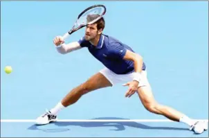  ?? WILLIAM WEST/AFP ?? Novak Djokovic hits a return during his match with Dominic Thiem of Austria at the Kooyong Classic in Melbourne yesterday.