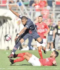  ??  ?? PASCAL GUYOT/AFP PSG’S Kylian Mbappe (L) is being tackled by Nimes’s Teji Savanier in an incident which led to PSG star being shown a red card during the French champion’s 4-2 victory at the Stade des Costieres in Nimes, France, on September 1, 2018.