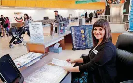 ??  ?? Travelers Aid Volunteer Coordinato­r Megan Chapman is at an informatio­n booth inside Will Rogers World Airport.