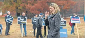  ?? FAITH NINIVAGGI / BOSTON HERALD ?? LOOKING FOR OPPORTUNIT­IES: Lori Trahan greets supporters and voters yesterday in front of the McCarthy Middle School in Chelmsford.