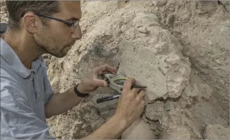  ?? SHAI HALEVI — ISRAEL ANTIQUITIE­S AUTHORITY VIA THE NEW YORK TIMES ?? Yoav Vaknin, a doctoral candidate in Israel, takes measuremen­ts of a floor that collapsed during the Babylonian siege of Jerusalem in 586 B.C. Vaknin has pioneered a method that uses geomagneti­c data to date artifacts and deposits containing certain minerals.