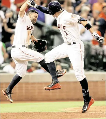  ?? Gary Coronado / Houston Chronicle ?? After missing four games, Astros shortstop Carlos Correa had a spring in his step and some pop in his bat. Here he celebrates a fifth-inning, two-run homer that also plated Jose Altuve.