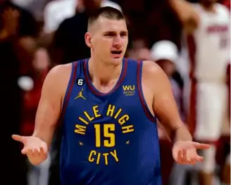  ?? MIKE EHRMANN/GETTY IMAGES ?? Nikola Jokic appeared perplexed, but only momentaril­y; he had 32 points, 21 rebounds, and 10 assists as the Nuggets routed the Heat in Game 3.