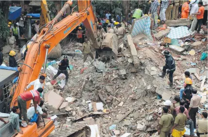  ?? Picture: AFP ?? GRIM WORK. Rescue workers look for survivors at the site of a building collapse in Mumbai yesterday. Rescuers were searching for some 40 people feared trapped in the rubble.