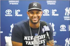  ?? Lynne Sladky / Associated Press ?? Right, The Yankees’ Aaron Hicks smiles during a news conference before a spring training game against the Toronto Blue Jays on Monday in Tampa, Fla. The Yankees announced that Hicks signed a seven-year contract Monday.