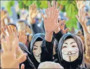  ?? AP ?? ■
Protesters in Guy Fawkes masks raise their hands as they chant slogans during a rally in Hong Kong on Tuesday.