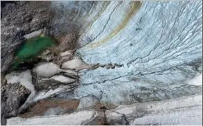  ?? ?? A small pool from a melting Schneefern­er Glacier is visible Aug. 15 below Germany’s highest mountain Zugspitze near Garmisch-Partenkirc­hen, Germany.