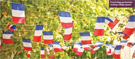  ??  ?? French flags garland decorating a village square