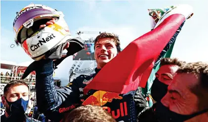  ?? GETTY IMAGES ?? Glad Max: Red Bull’s Verstappen waves the Mexican flag as he celebrates his victory