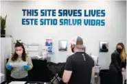  ?? AP PHOTO/SETH WENIG ?? A sign on the wall reads “This site save lives” in Spanish and English on Feb. 18 at an overdose prevention center at OnPoint NYC in New York.