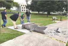  ?? THE ASSOCIATED PRESS ?? Personnel from the Secretary of State’s office inspects the damage to the new Ten Commandmen­ts monument outside the state Capitol in Little Rock, Ark., Wednesday, after someone crashed into it with a vehicle, less than 24 hours after the privately...