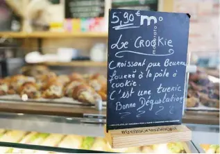  ?? ?? This photograph shows a sign announcing “Crookies”, a traditiona­l French croissant mixed with a cookie dough, in the pastry shop of French pastry chef Stephane Louvard in Paris. — AFP photos