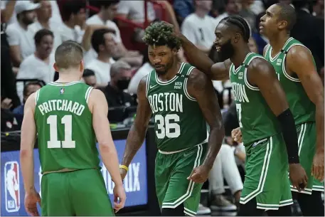  ?? AP ?? GETTING IT DONE: Celtics guard Marcus Smart (36) celebrates with his teammates during the second half of Game 2 of the Eastern Conference Finals against the Heat on Thursday night in Miami.