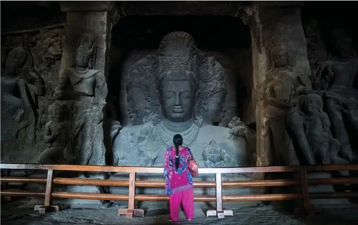  ??  ?? An ancient Hindu stone carving beckons at Elephanta Caves in India.