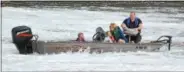  ??  ?? A unidentifi­ed family of four, stranded at Black Rock Dam on the Schuylkill River, awaits rescue Thursday evening.