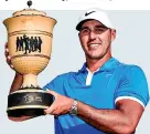  ?? EPA ?? Special victory: Brooks Koepka shows off his trophy