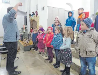  ?? FOTO: MARKUS LEHMANN ?? Die Kinderstim­men erklingen fröhlich beim „Gloria in excelsis Deo“– auch wenn es keine echten Tiere gibt bei dem Krippenvor­spiel.