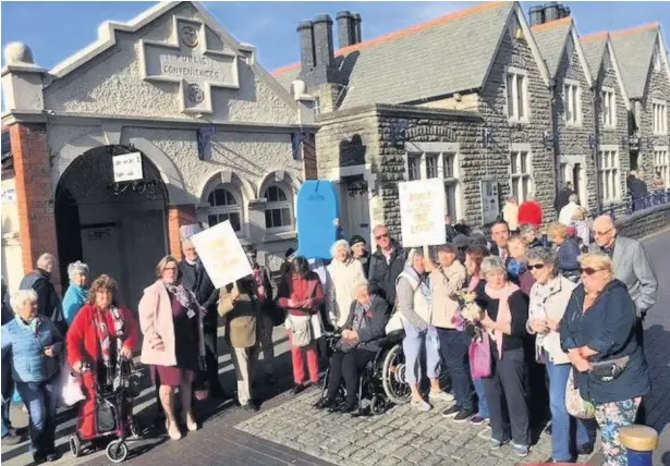  ??  ?? Protesters gather outside Porthcawl town centres public toilets which are threatened with closure