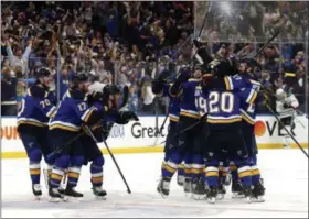  ?? JEFF ROBERSON - THE ASSOCIATED PRESS ?? FILE - In this May 7, 2019, file photo, St. Louis Blues celebrate after defeating the Dallas Stars in double overtime in Game 7 of an NHL second-round hockey playoff series in St. Louis.