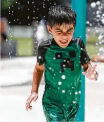  ?? Jason Fochtman / Staff photograph­er ?? Splash pads at Martin Luther King Jr. Park in Conroe are open, giving kids a cool place to beat the Texas sun’s heat.