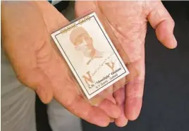  ?? ?? Pitrof holds a reproducti­on rookie-style card for Graham on June 15 in Baltimore. The card was made decades after Graham’s one game in the major leagues.